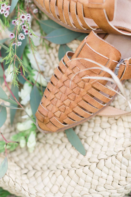 genuine braided leather strappy front sandal with closed toe and open back. 1 inch heel and pretty buckle accent.