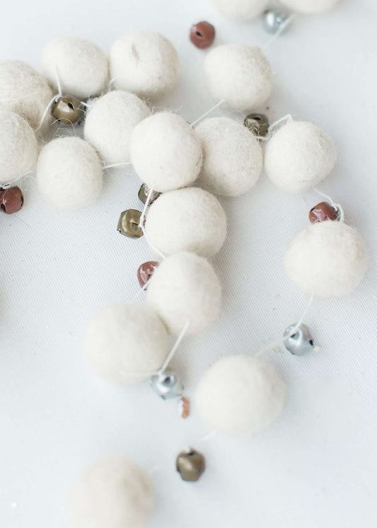 white, brown, olive felt garland balls on a string